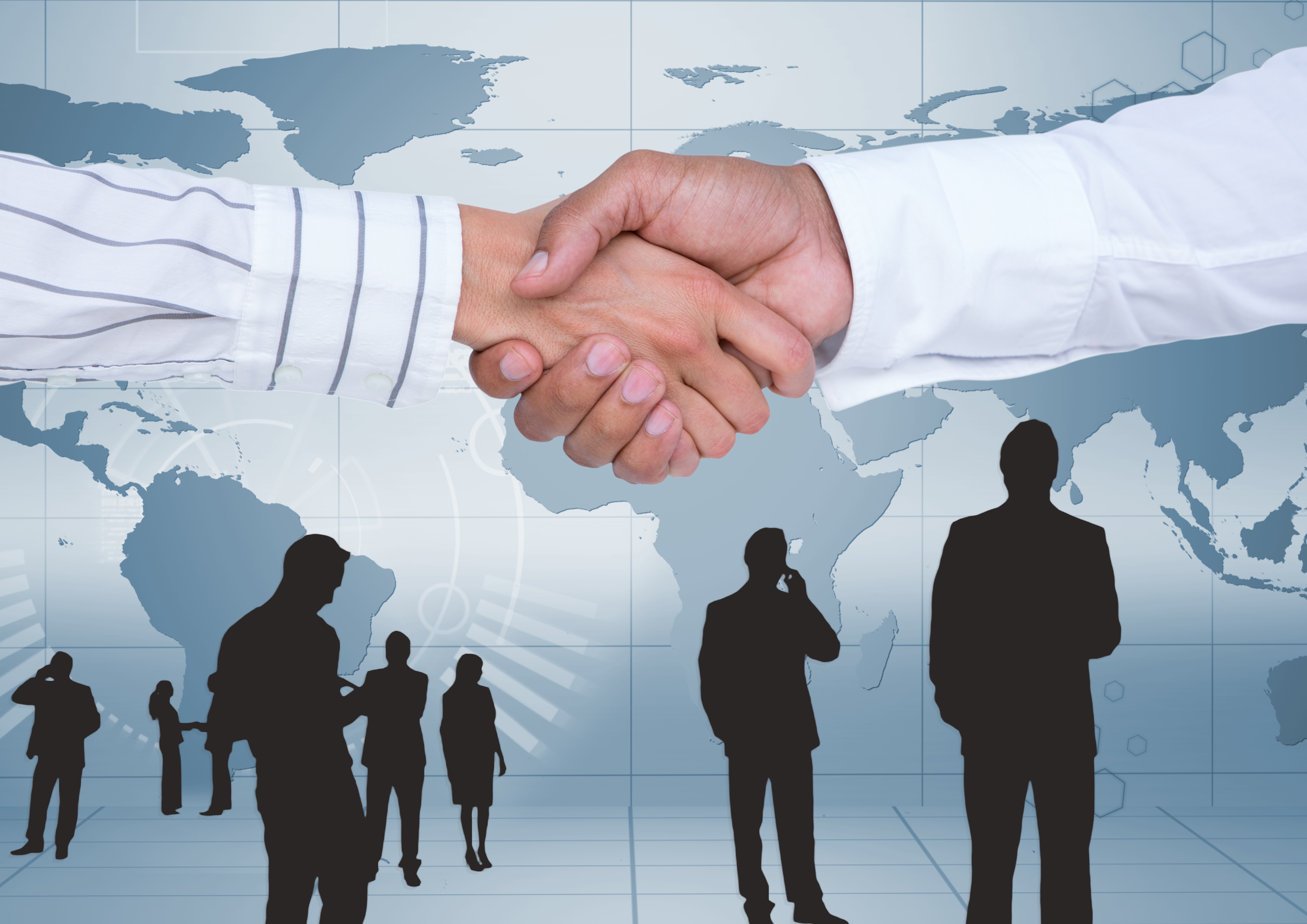 Businesspeople shaking hands against map background